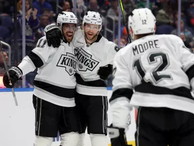 Dec 10, 2024; Elmont, New York, USA; Los Angeles Kings right wing Adrian Kempe (9) celebrates his goal against the New York Islanders with center Anze Kopitar (11) and left wing Trevor Moore (12) during the first period at UBS Arena. Mandatory Credit: Brad Penner-Imagn Images