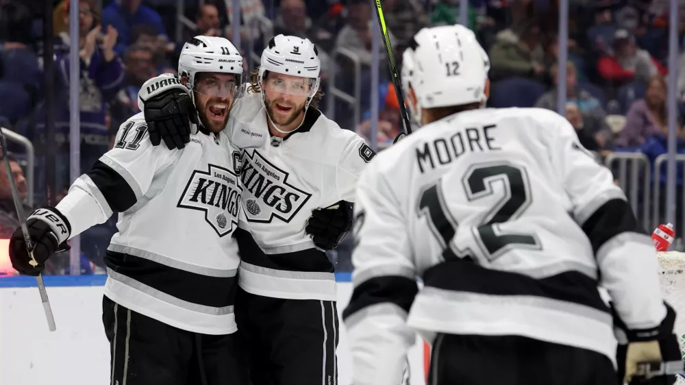 Dec 10, 2024; Elmont, New York, USA; Los Angeles Kings right wing Adrian Kempe (9) celebrates his goal against the New York Islanders with center Anze Kopitar (11) and left wing Trevor Moore (12) during the first period at UBS Arena. Mandatory Credit: Brad Penner-Imagn Images