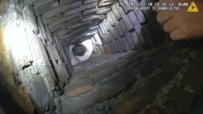 This image provided by City of Fall River Police Department shows police encounter of a man attempting to evade arrest by hiding inside a chimney on Tuesday, Dec. 10, 2024 in Fall River, Mass. (City of Fall River Police Department via AP) 