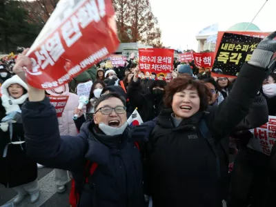 14 December 2024, South Korea, Seoul: Protesters cheer near the National Assembly following the passage of an impeachment motion against President Yoon Suk Yeol. The motion passed with a vote of 204-85, including three abstentions and eight invalid ballots. Photo: -/YNA/dpa