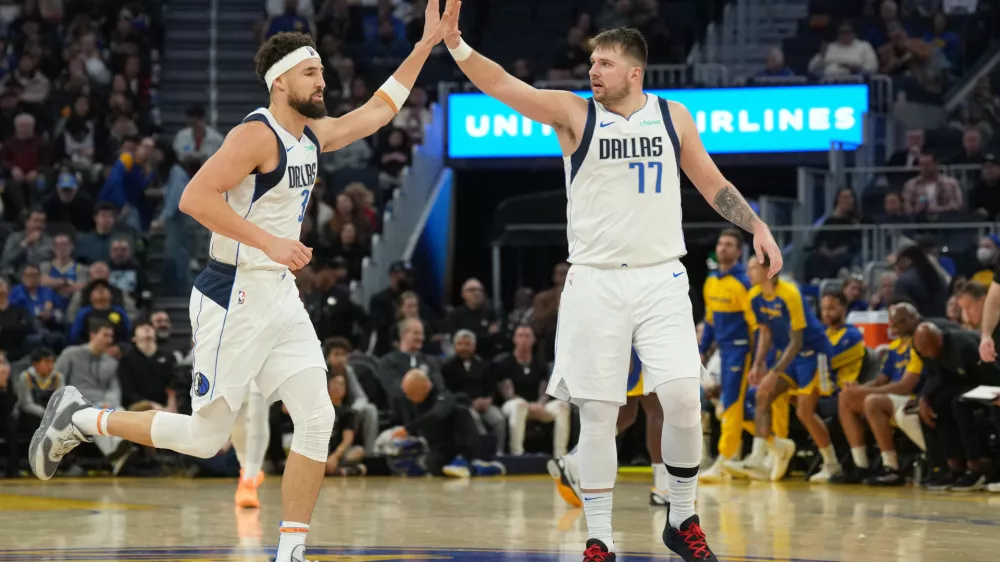 Dec 15, 2024; San Francisco, California, USA; Dallas Mavericks guard Klay Thompson (left) is congratulated by guard Luka Doncic (77) after scoring against the Golden State Warriors during the third quarter at Chase Center. Mandatory Credit: Darren Yamashita-Imagn Images