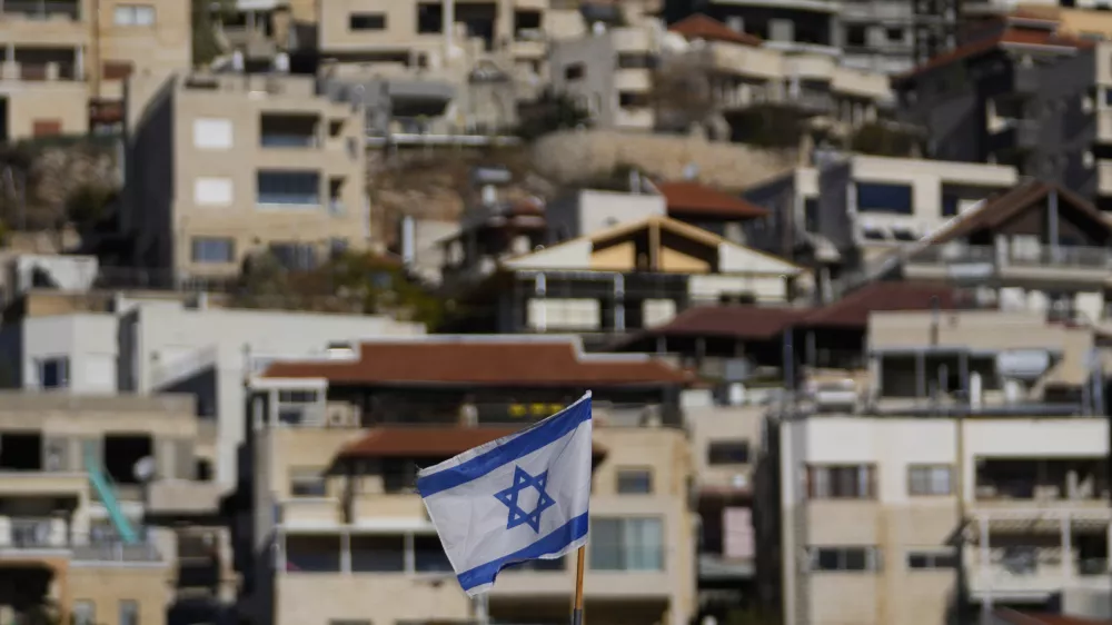 An Israeli flag flies on a roof in the town of Majdal Shams, near the so-called Alpha Line that separates the Israeli-controlled Golan Heights from Syria, Sunday, Dec. 15, 2024. (AP Photo/Matias Delacroix)