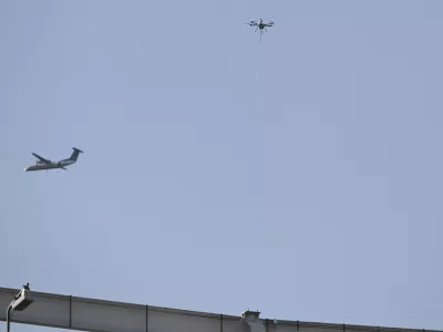 Dec 14, 2024; Landover, Maryland, USA;  An aircraft fly near a tethered drone during the first half of the125 plays of the Army-Navy game at Commanders Field. Mandatory Credit: Tommy Gilligan-Imagn Images