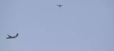 Dec 14, 2024; Landover, Maryland, USA;  An aircraft fly near a tethered drone during the first half of the125 plays of the Army-Navy game at Commanders Field. Mandatory Credit: Tommy Gilligan-Imagn Images