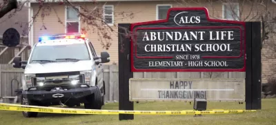 Emergency vehicles are parked outside the Abundant Life Christian School in Madison, Wis., following a shooting, Monday, Dec. 16, 2024. (AP Photo/Morry Gash)