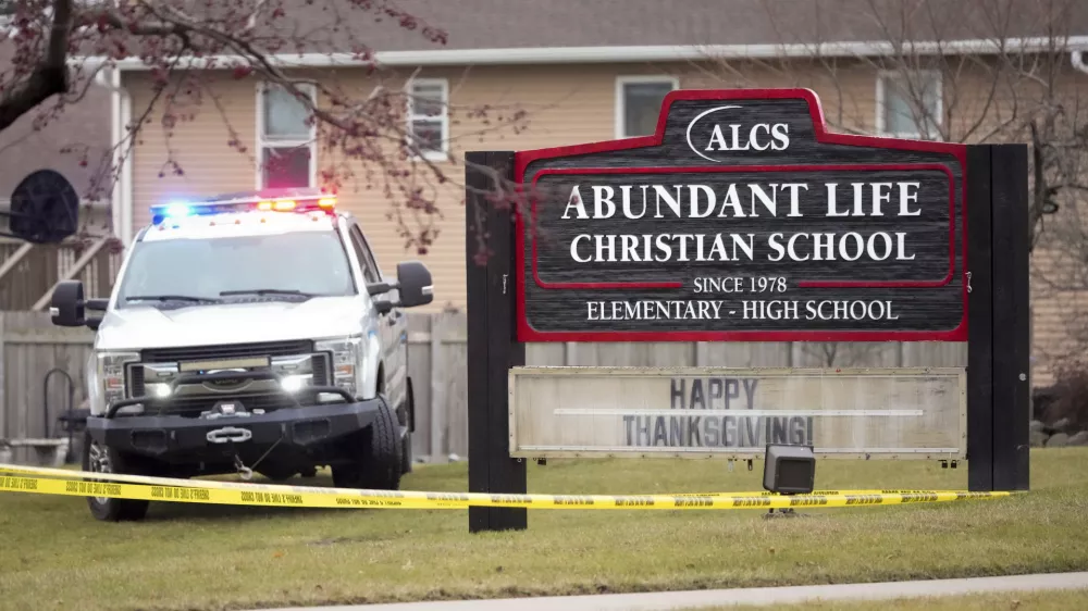 Emergency vehicles are parked outside the Abundant Life Christian School in Madison, Wis., following a shooting, Monday, Dec. 16, 2024. (AP Photo/Morry Gash)