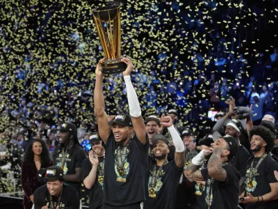 Dec 17, 2024; Las Vegas, Nevada, USA; Milwaukee Bucks forward Giannis Antetokounmpo (34) celebrates with the trophy and teammates after winning the Emirates NBA Cup championship game against the Oklahoma City Thunder at T-Mobile Arena. Mandatory Credit: Kyle Terada-Imagn Images