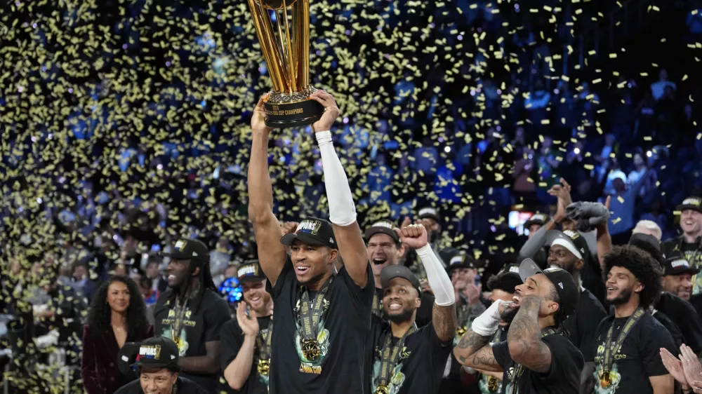 Dec 17, 2024; Las Vegas, Nevada, USA; Milwaukee Bucks forward Giannis Antetokounmpo (34) celebrates with the trophy and teammates after winning the Emirates NBA Cup championship game against the Oklahoma City Thunder at T-Mobile Arena. Mandatory Credit: Kyle Terada-Imagn Images