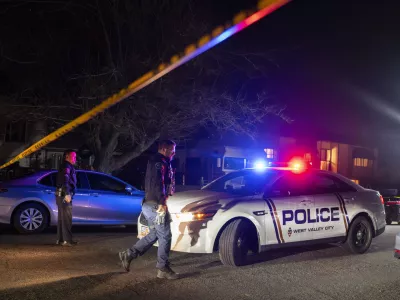 Police investigate a crime scene where they say multiple family members were found dead inside a home in West Valley City, Utah, Tuesday Dec. 17, 2024. (Scott G. Winterton/The Deseret News via AP)