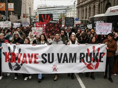 Students of Belgrade University block the street for fifteen minutes to pay their respect for fifteen victims of a fatal roof collapse at Novi Sad's railway station in Belgrade, Serbia, December 13, 2024. REUTERS/Marko Djurica