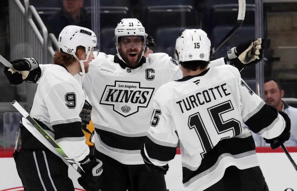 Dec 17, 2024; Pittsburgh, Pennsylvania, USA; Los Angeles Kings right wing Adrian Kempe (9) celebrates after scoring a goal with center Anze Kopitar (11) and center Alex Turcotte (15) during the first period against the Pittsburgh Penguins at PPG Paints Arena. Mandatory Credit: Charles LeClaire-Imagn Images