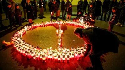 People lay candles following a knife attack in a primary school, in Zagreb, Croatia, December 20, 2024. REUTERS/Antonio Bronic