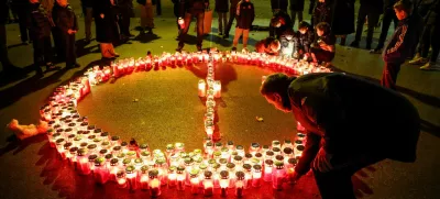 People lay candles following a knife attack in a primary school, in Zagreb, Croatia, December 20, 2024. REUTERS/Antonio Bronic