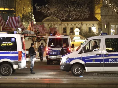 Police officers and police emergency vehicles are seen at the Christmas market in Magdeburg after a driver plowed into a busy Christmas market in Magdeburg, Germany, Saturday, Dec. 21, 2024. (Matthias Bein/dpa via AP)