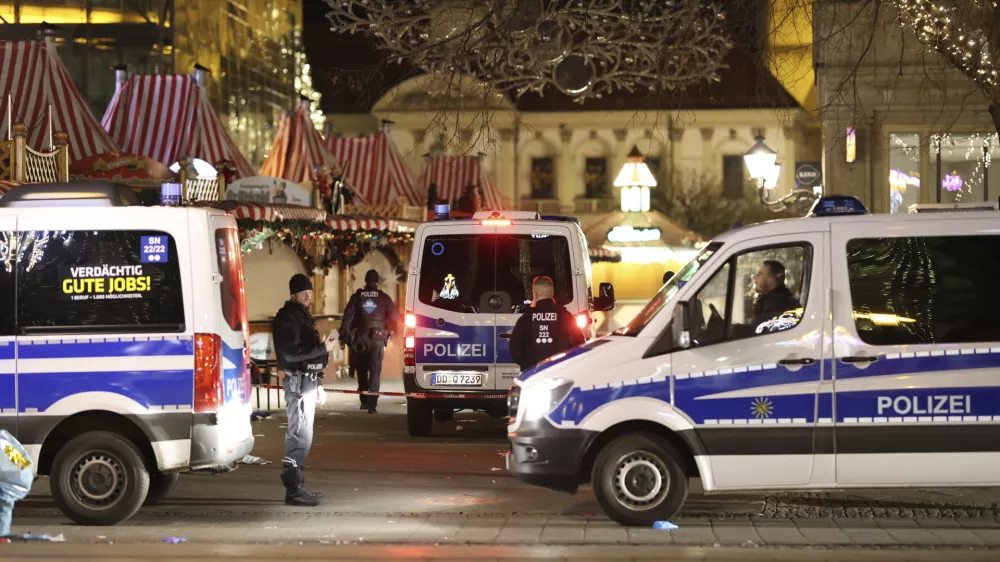 Police officers and police emergency vehicles are seen at the Christmas market in Magdeburg after a driver plowed into a busy Christmas market in Magdeburg, Germany, Saturday, Dec. 21, 2024. (Matthias Bein/dpa via AP)