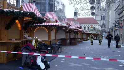 Police and firefighters walk at a cordoned-off Christmas Market, where a car drove into a crowd on Friday evening, in Magdeburg, Germany, Saturday, Dec. 21, 2024. (AP Photo/Michael Probst)