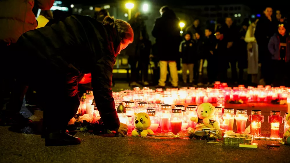 A person lays a candle following a knife attack in a primary school, in Zagreb, Croatia, December 20, 2024. REUTERS/Antonio Bronic