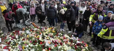 Citizens pay tribute for deaths outside St. John's Church near a Christmas Market, where a car drove into a crowd on Friday evening, in Magdeburg, Germany, Saturday, Dec. 21, 2024. (AP Photo/Ebrahim Noorozi)