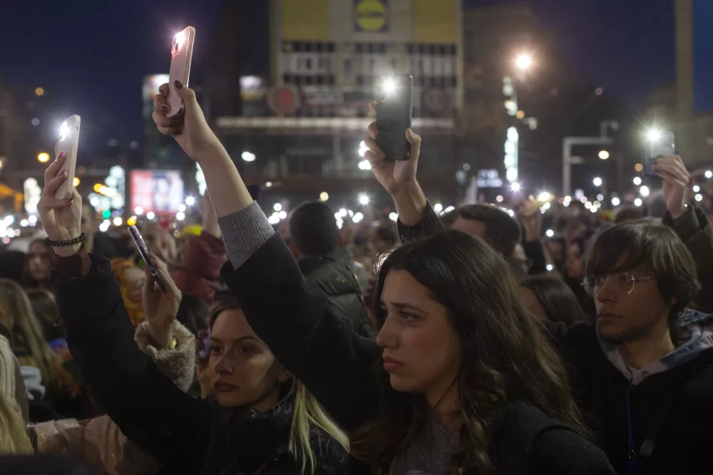 People use lights on their mobile phones during a protest against populist President Aleksandar Vucic and his government, whose tight grip on power has been challenged by weeks of street protests led by university students, in Belgrade, Serbia, Sunday, Dec. 22, 2024. (AP Photo/Marko Drobnjakovic)