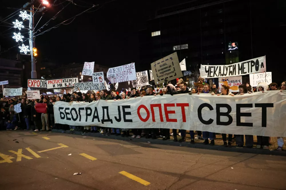 People carry a banner that reads ''Belgrade is world again'', during a protest against government policies, corruption and the negligence which they blame for the deaths of the victims in the Novi Sad railway station disaster in November, in Belgrade, Serbia, December 22, 2024. REUTERS/Zorana Jevtic