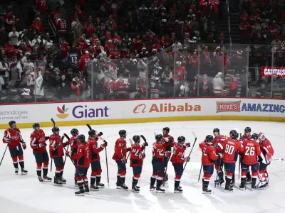 Washington Capitals players greet each other after defeating the Los Angeles Kings in an NHL hockey game, Sunday, Dec. 22, 2024, in Washington. (AP Photo/Terrance Williams)