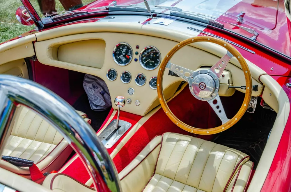 2JHE5A4 Cream and red leather interior of a 1975 Shelby Cobra classic sports car in red at The Berkshire Motor Show in Reading, UK