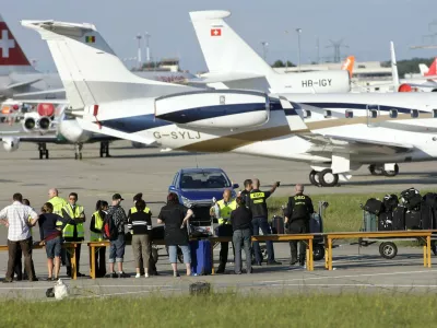 Passengers of an Airbus A-320 of the airline company Swiss International Airlines identify their lugage on the tarmac of the Cointrin airport in Geneva, Switzerland, Saturday, Aug. 23, 2008. The plane coming from Zurich and heading for Malaga, was forced to make an emergency landing in Geneva after an bomb threat from Spain. The plane with 142 passengers and six crew members on board landed safely at Geneva airport. All passengers left the plane by escape slides and were unharmed. The author and the motif of the threat are still unknown. (A Photo/KEYSTONE/Salvatore Di Nolfi)