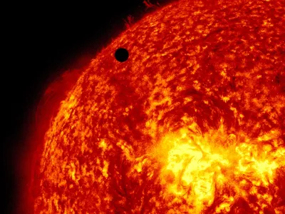 This image provided by NASA shows the Solar Dynamic Observatory's ultra-high definition view of Venus, black dot at top center, passing in front of the sun on Tuesday, June 5, 2012. The next transit of Venus won't be for another 105 years. (AP Photo/NASA/Solar Dynamic Observatory)