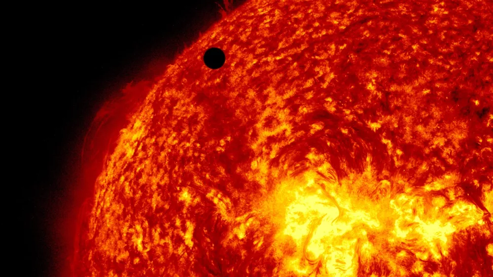 This image provided by NASA shows the Solar Dynamic Observatory's ultra-high definition view of Venus, black dot at top center, passing in front of the sun on Tuesday, June 5, 2012. The next transit of Venus won't be for another 105 years. (AP Photo/NASA/Solar Dynamic Observatory)