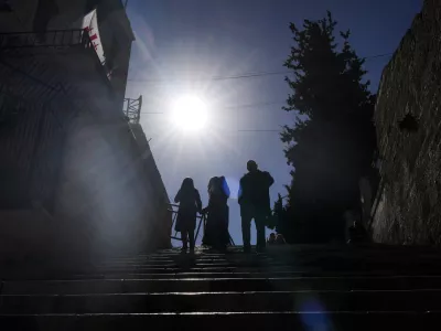 Worshippers walk down the stairs next to the Christmas morning Mass at the Chapel of Saint Catherine, traditionally believed to be the birthplace of Jesus, in the West Bank city of Bethlehem, Wednesday, Dec. 25, 2024. (AP Photo/Matias Delacroix)