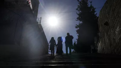 Worshippers walk down the stairs next to the Christmas morning Mass at the Chapel of Saint Catherine, traditionally believed to be the birthplace of Jesus, in the West Bank city of Bethlehem, Wednesday, Dec. 25, 2024. (AP Photo/Matias Delacroix)