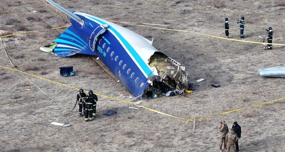 A drone view shows emergency specialists working at the crash site of an Azerbaijan Airlines passenger plane near the city of Aktau, Kazakhstan December 25, 2024. REUTERS/Azamat Sarsenbayev   TPX IMAGES OF THE DAY