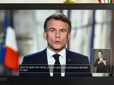 01 January 2025, France, Clermont-Ferrand: French President Emmanuel Macron pictured on a computer screen as he delivers his annual New Year's adress to the nation. Photo: Adrien Fillon/ZUMA Press Wire/dpa