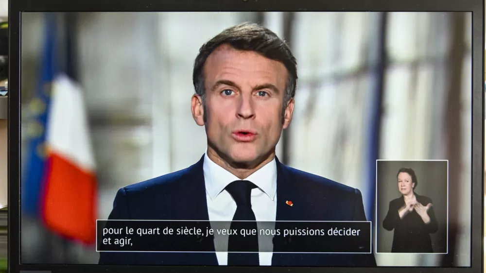 01 January 2025, France, Clermont-Ferrand: French President Emmanuel Macron pictured on a computer screen as he delivers his annual New Year's adress to the nation. Photo: Adrien Fillon/ZUMA Press Wire/dpa