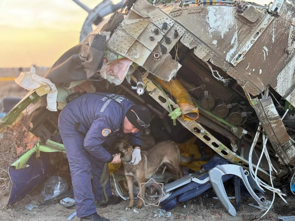 An emergency specialist with a dog works at the crash site of an Azerbaijan Airlines' Embraer passenger plane near the city of Aktau, Kazakhstan, December 26, 2024. Kazakhstan Emergencies Ministry/Handout via REUTERS ATTENTION EDITORS - THIS IMAGE HAS BEEN SUPPLIED BY A THIRD PARTY. NO RESALES. NO ARCHIVES. MANDATORY CREDIT. WATERMARK FROM SOURCE.