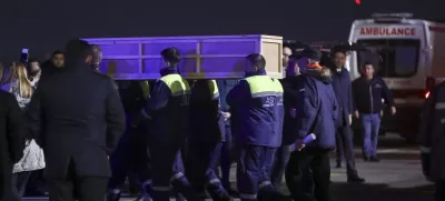 Workers carry a coffin with a body of a victim from a medical plane after the Azerbaijani Airline crashed, near the Kazakhstani city of Aktau, upon their arrival at the Heydar Aliyev International Airport outside Baku, Azerbaijan, Thursday, Dec. 26, 2024. (AP Photo)