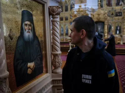 A recovering Ukrainian soldier looks at the icon of a saint inside the church of the Skete of Prophet Elijah in Mount Athos, Greece, November 26, 2024. In their four-day stay, part of a psychological support programme organised by Ukrainian authorities, the 22 soldiers made a pilgrimage to some dozen monasteries on the slopes of Mount Athos, a spiritual centre since the 10th century. "A lot of servicemen suffer from the events that took place over the last three years. A lot of them suffer from different illnesses – they are wounded, and we have to rehabilitate them," said Father Mykhailo Pasirskyi, a Ukrainian Orthodox priest. REUTERS/Alexandros Avramidis     SEARCH "AVRAMIDIS UKRAINE ATHOS" FOR THIS STORY. SEARCH "WIDER IMAGE" FOR ALL STORIES.