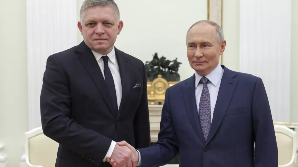 Russian President Vladimir Putin, right, and Slovak Prime Minister Robert Fico shake hands during their meeting at the Kremlin in Moscow, Russia, Sunday, Dec. 22, 2024. (Gavriil Grigorov, Sputnik, Kremlin Pool Photo via AP)