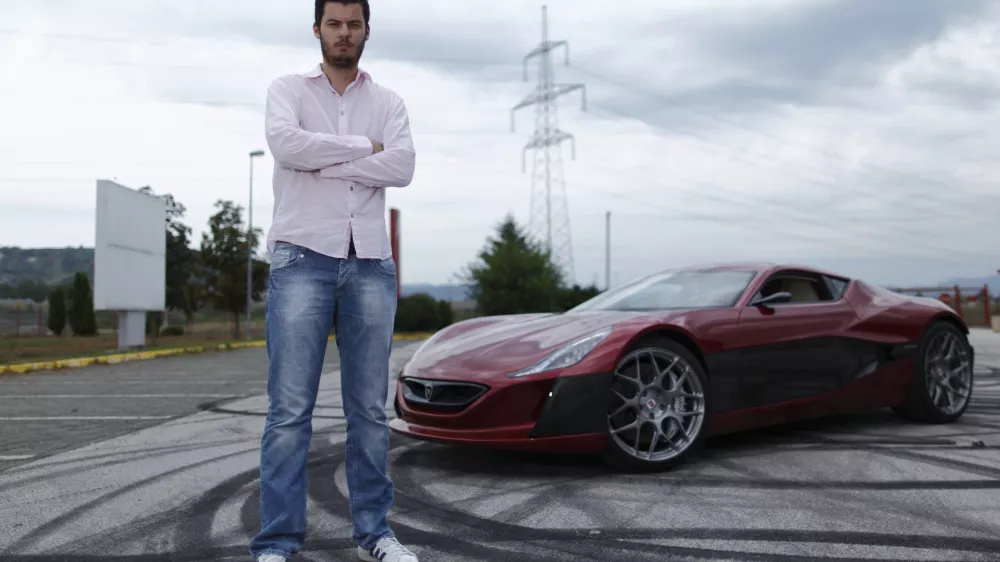 ﻿Mate Rimac owner of Rimac Automobili poses with the Concept One car in Zagreb August 31, 2012. Croatian concept car manufacturer Rimac Automobili based near Zagreb prepares to unveil a prototype of their Concept One electric supercar at the upcoming Salon Privé car show in London in early September.The Concept One has a carbon fiber body an electric motor powering each wheel, and can produce 1,088 horse powers, capable of achieving top speed of around 305 kmh (190 mph) with a range of 600 kilometres (373 miles), making it the world's fastest electric car. Costing around $1 million each, only 13 of these high-end electric cars are expected to be produced per year. Picture taken August 31, 2012. REUTERS/Antonio Bronic (CROATIA - Tags: TRANSPORT BUSINESS) - RTR37CTI