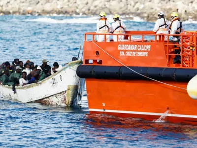 A Spanish Coast Guard vessel tows a fibreglass boat with migrants onboard to the port of Arguineguin, on the island of Gran Canaria, Spain, December 25, 2024. REUTERS/Borja Suarez