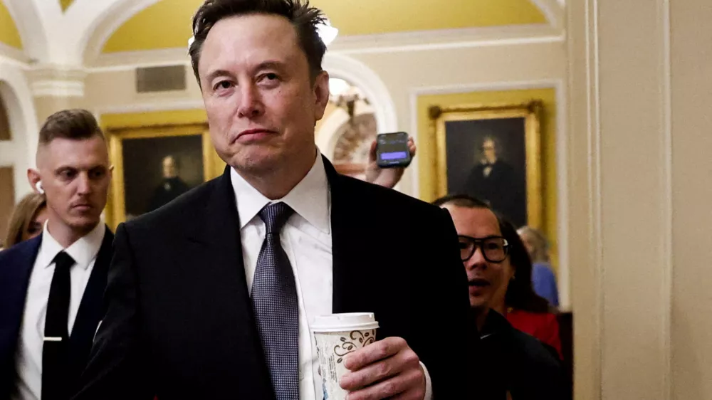 FILE PHOTO: Elon Musk walks on Capitol Hill on the day of a meeting with Senate Republican Leader-elect John Thune (R-SD), in Washington, U.S. December 5, 2024. REUTERS/Benoit Tessier/File Photo