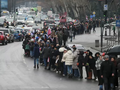 Demonstrators line up in a human chain during an anti-government rally in the center of Tbilisi, Georgia, on Saturday, Dec. 28, 2024. (AP Photo/Zurab Tsertsvadze)