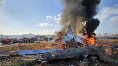 In this photo provided by South Korea's Muan Fire Station, a passenger plane is in flames at the Muan International Airport in Muan, South Korea, Sunday, Dec. 29, 2024. (South Korea's Muan Fire Station via AP)