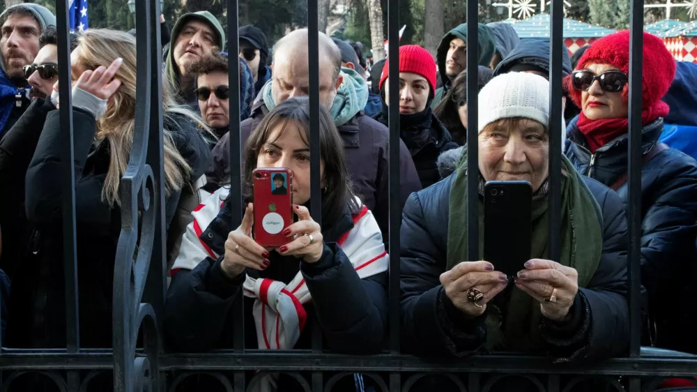 People gather outside the fence of the Orbeliani presidential palace before the address of outgoing Georgia's President Salome Zourabichvili to supporters and journalists on the day of the swearing-in ceremony of new Georgia's president Mikheil Kavelashvili, in Tbilisi, Georgia December 29, 2024. REUTERS/Daro Sulakauri