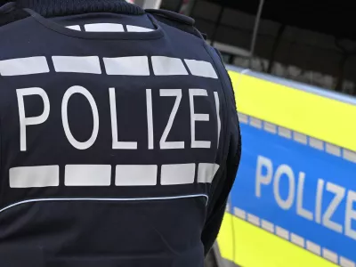 FILED - 03 December 2024, Baden-Württemberg, Stuttgart: A policeman is pictured next to a police car in Stuttgart. Photo: Bernd Weißbrod/dpa