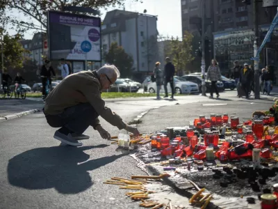 A man lights a candle to pay his respects to the people who died when a part of the roof collapsed at a railway station in Novi Sad, Serbia November 2, 2024. REUTERS/Marko Djurica