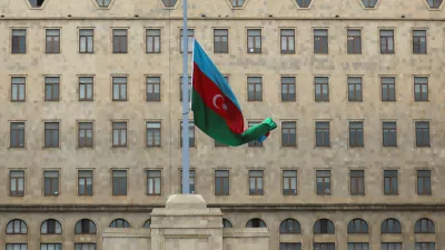 FILE PHOTO: An Azeri state flag flies at half-mast as the country observes day of national mourning for the victims of an Azerbaijan Airlines' Embraer passenger plane crash near the Kazakh city of Aktau, outside the Government House in Baku, Azerbaijan, December 26, 2024. REUTERS/Aziz Karimov/File Photo