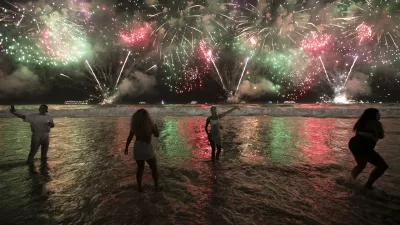 FILE - People celebrate the start of the New Year as fireworks illuminate Copacabana Beach in Rio de Janeiro, Brazil, early Monday, Jan. 1, 2024. (AP Photo/Bruna Prado, File)