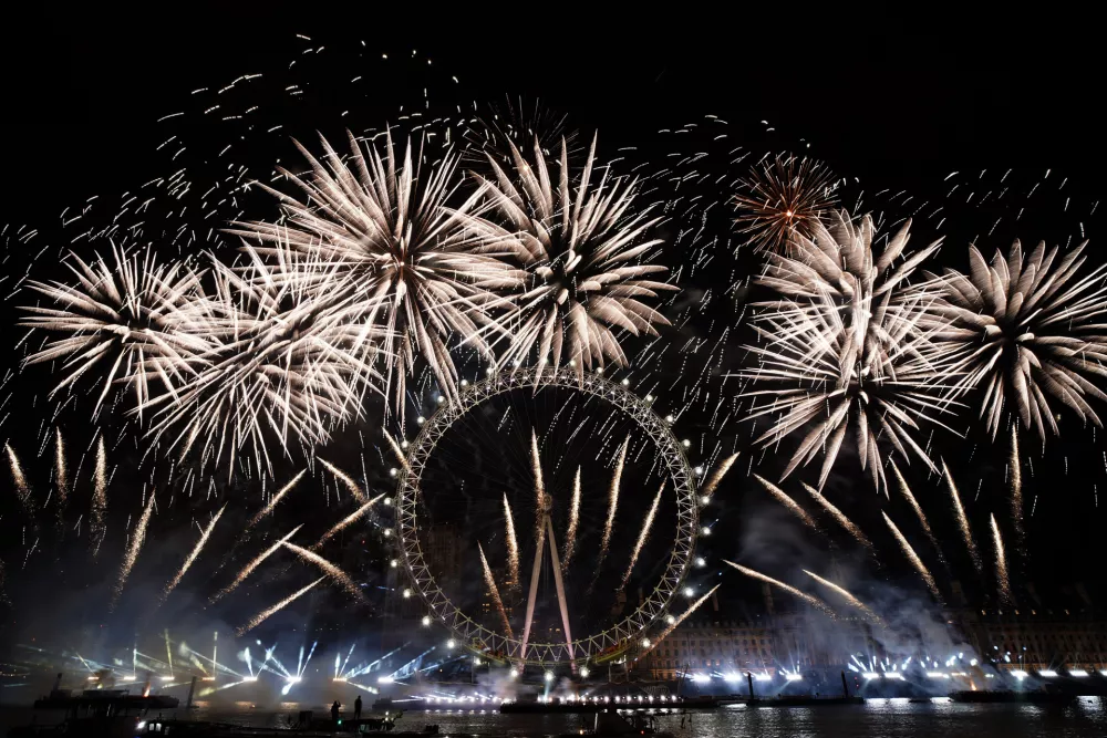 FILE - Fireworks light-up the sky over the London Eye in central London to celebrate the New Year on Monday, Jan. 1, 2024. (AP Photo/Alberto Pezzali, File)