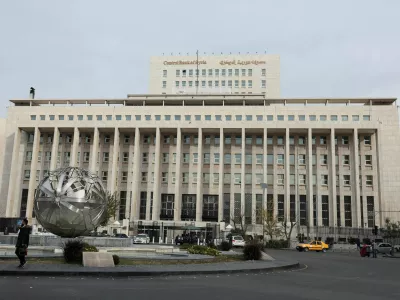 FILE PHOTO: People and cars are seen in front of the Central Bank of Syria, after rebels seized the capital and ousted Syria's Bashar al-Assad, in Damascus, Syria December 11, 2024. REUTERS/Amr Abdallah Dalsh/File Photo